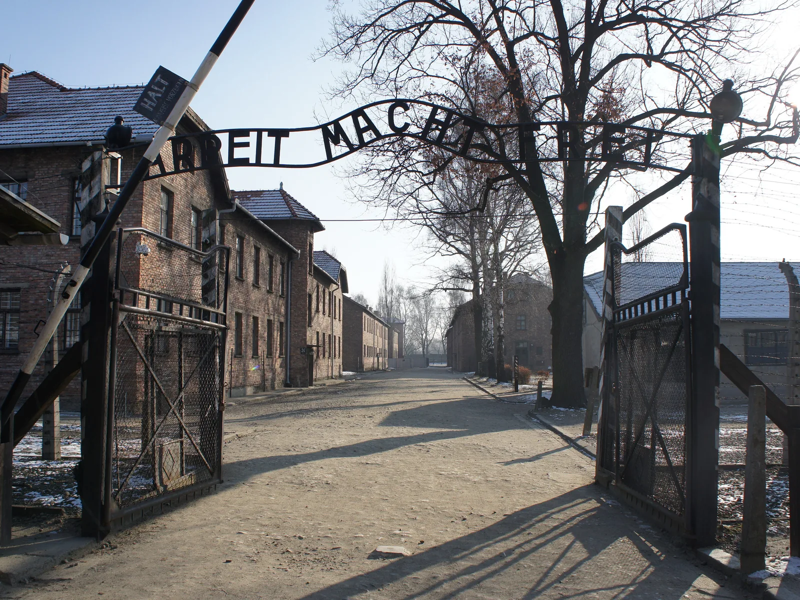 The main entrance to the German death camp Auschwitz I near the town of Oświęcim in Poland. Above the gate is the infamous motto, Arbeit macht frei ("work makes