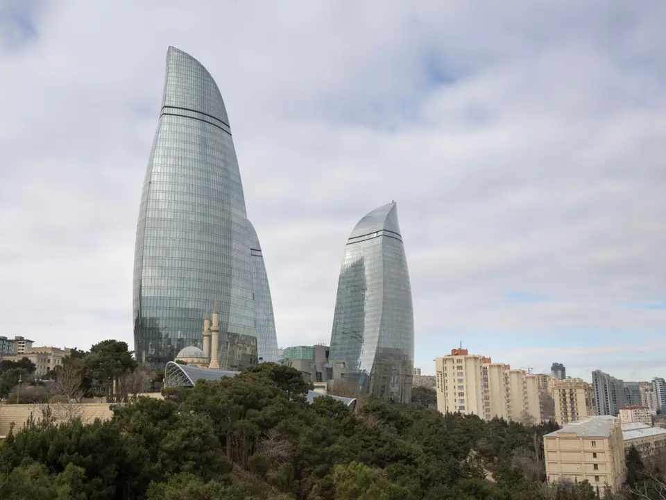 Stunning view of Baku's Flame Towers with surrounding urban park and cityscape