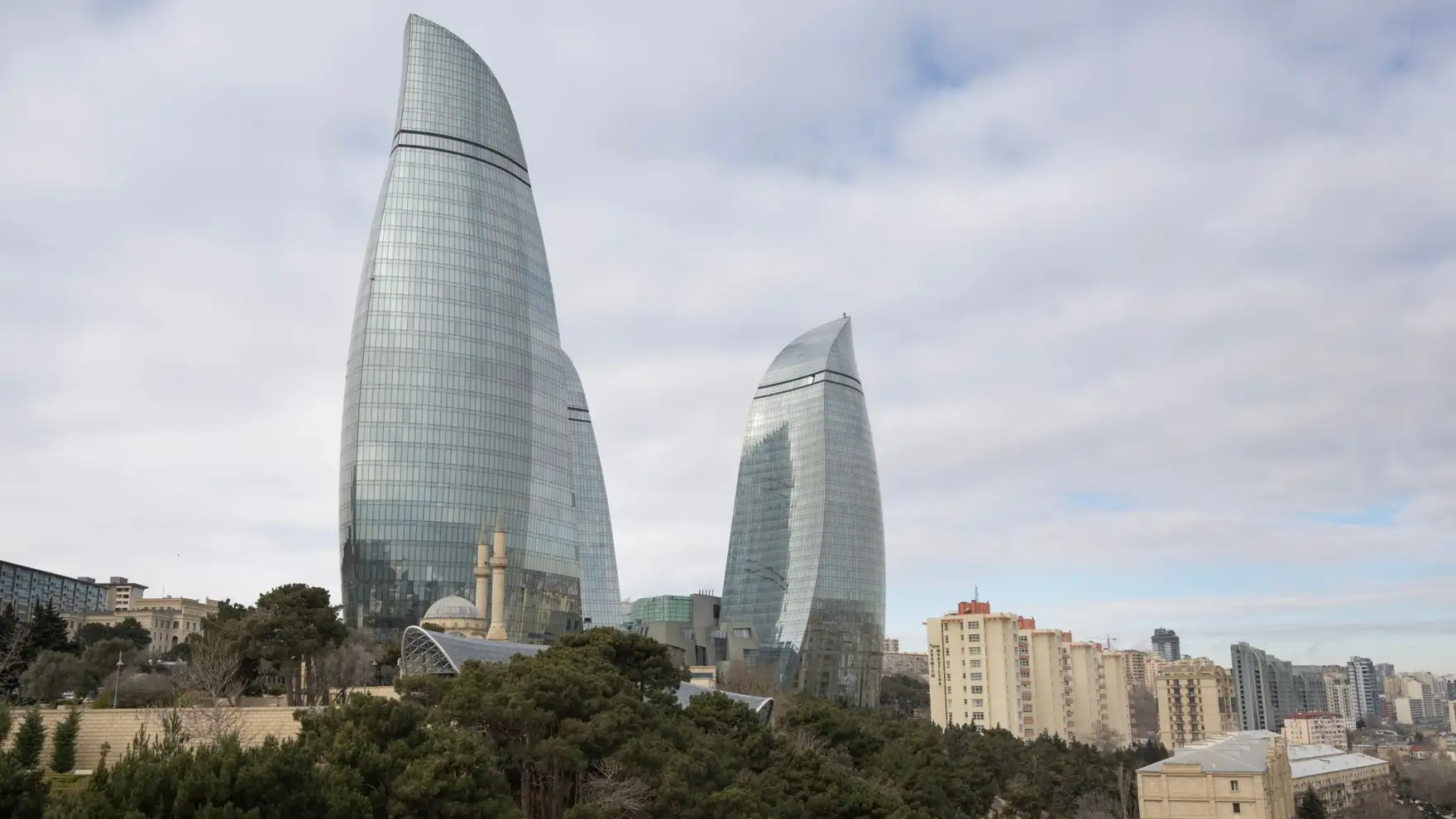 Stunning view of Baku's Flame Towers with surrounding urban park and cityscape