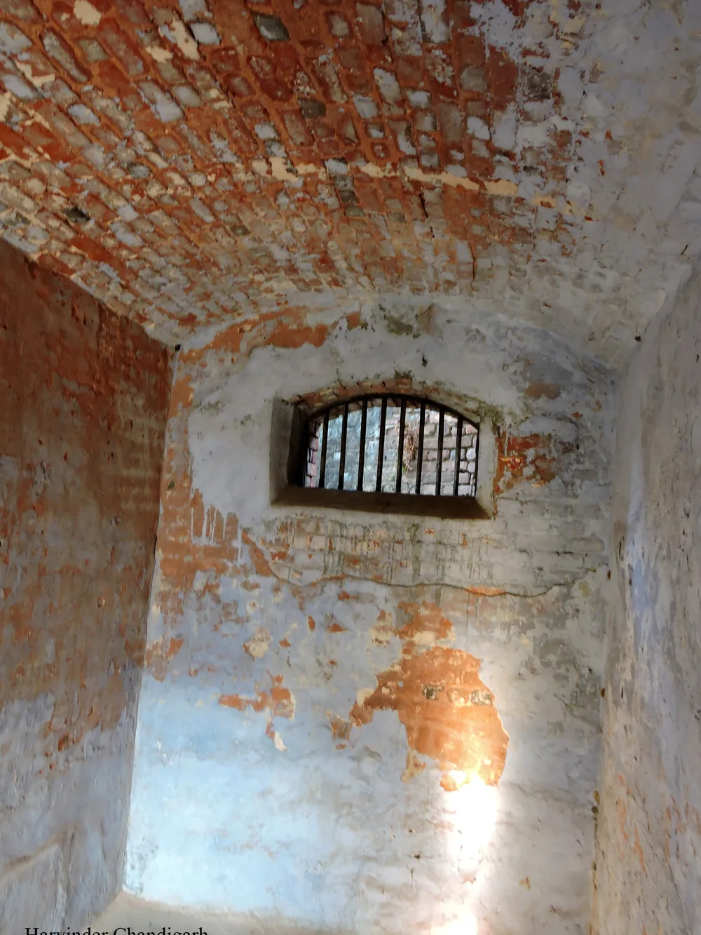 Inside a cell of the Cellular Jail: bare walls and one barred window