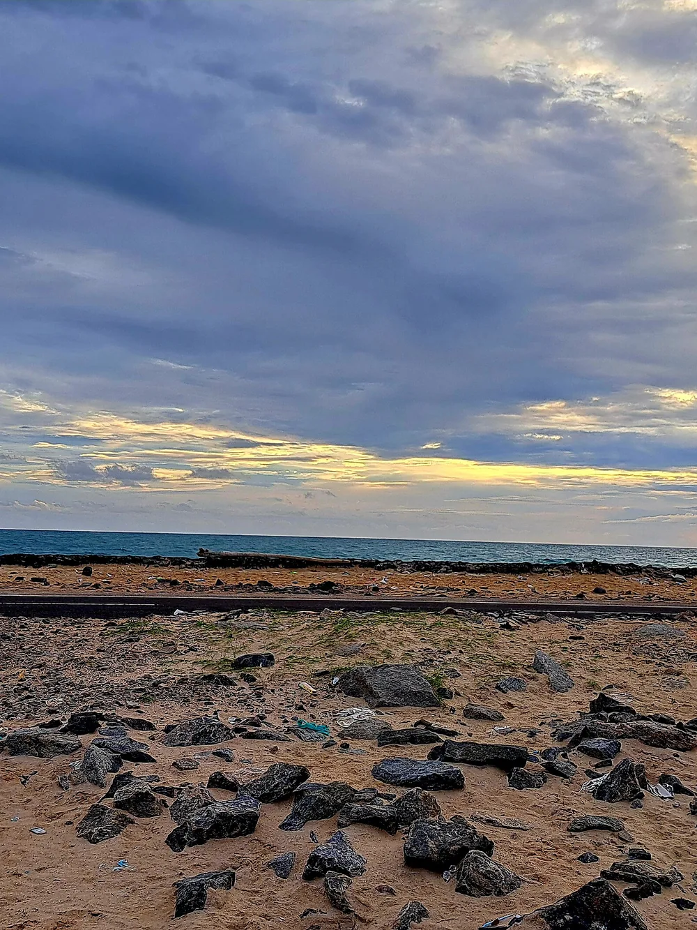 The sand road to Dhanushkodi under a wide evening sky