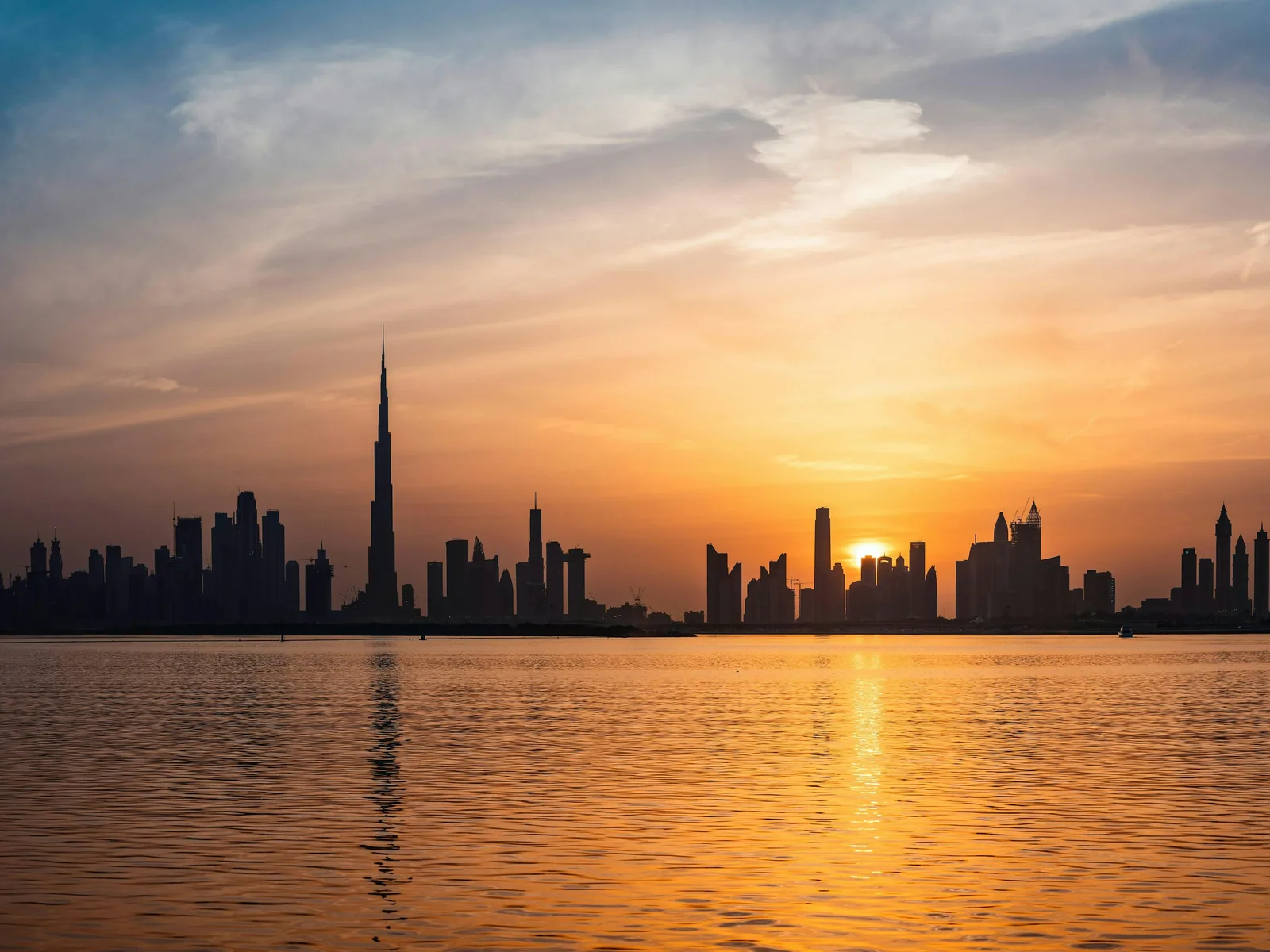 The sun is setting over the city skyline