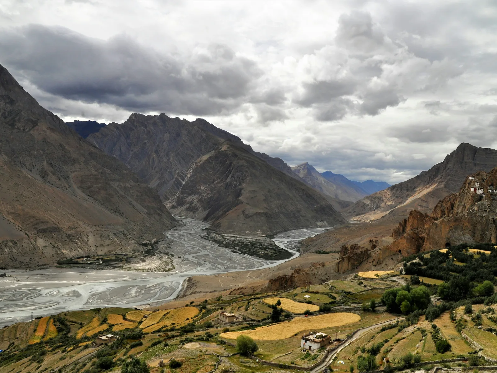 brown and green mountains under white clouds during daytime