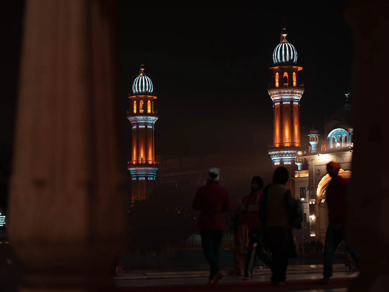 Illuminated towers of the Golden Temple in Amritsar, India, captured at night