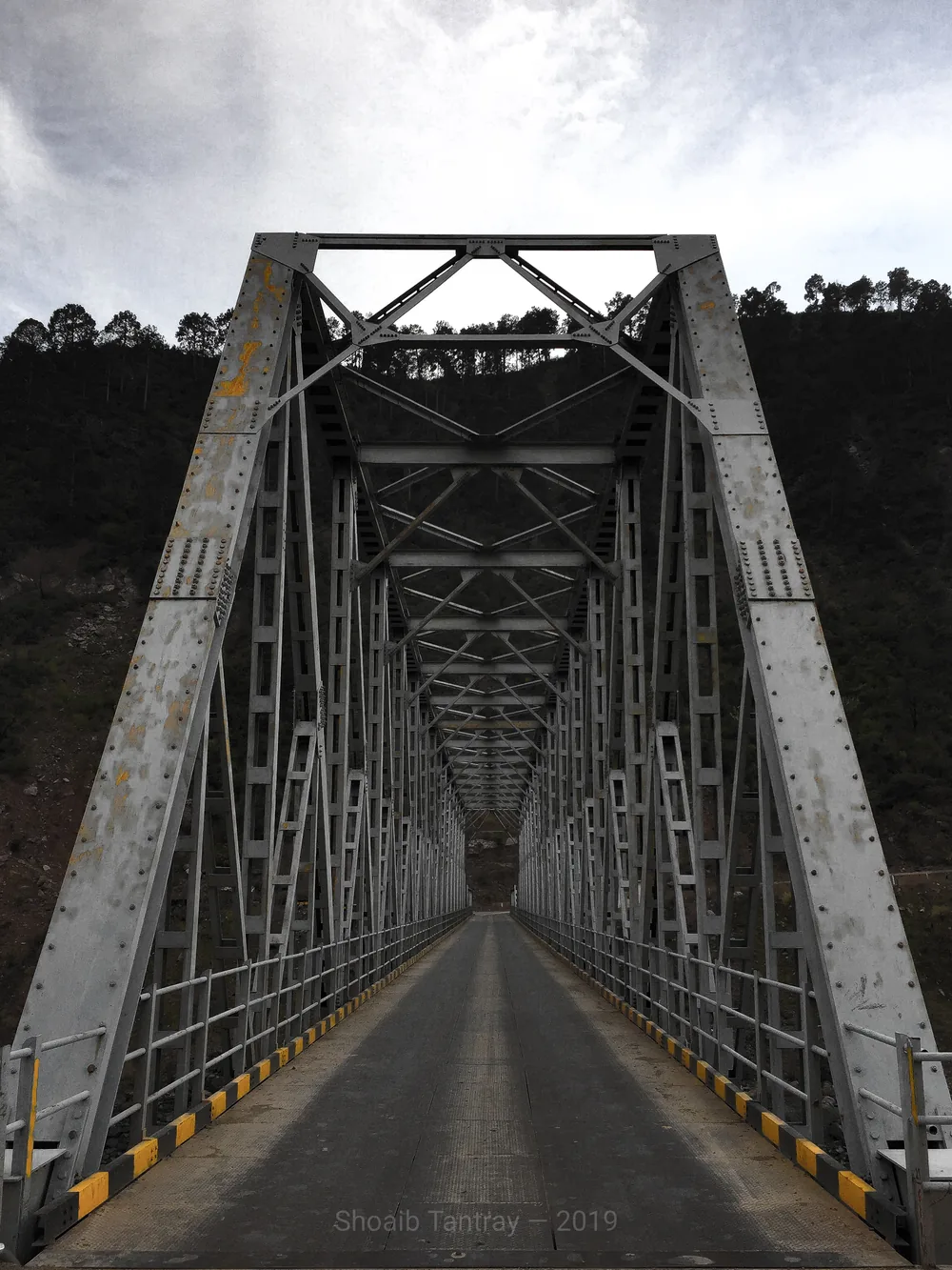 A steel girder bridge carries NH44 across the Chenab River at Dharmkund, Ramban district