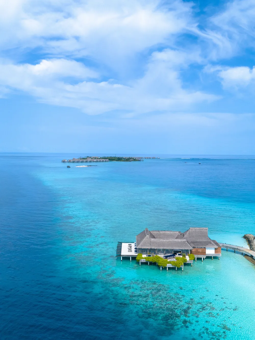 Turquoise reef waters framing an overwater villa in the Maldives