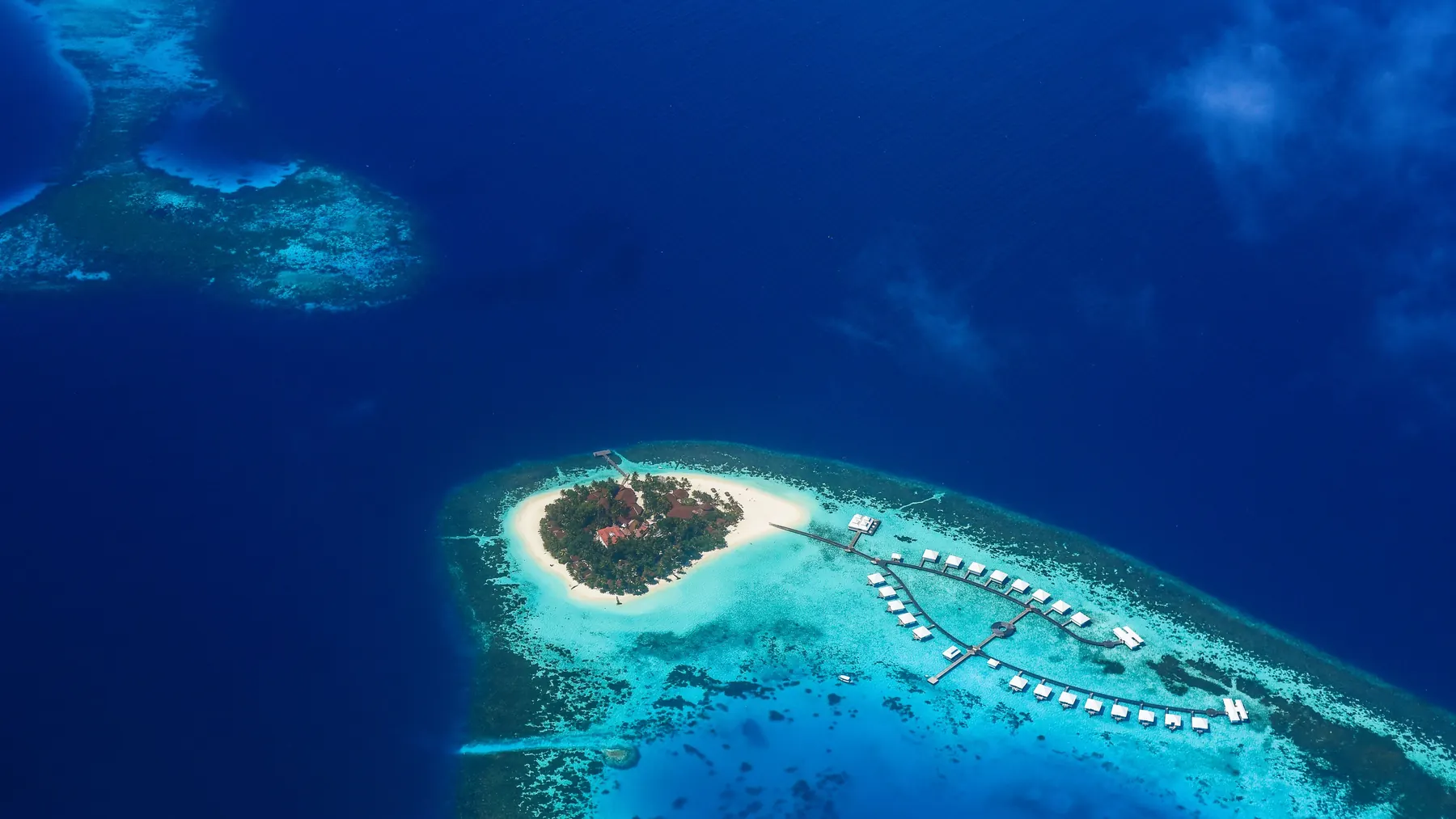 Stunning aerial shot of a tropical island paradise surrounded by turquoise waters in the Maldives