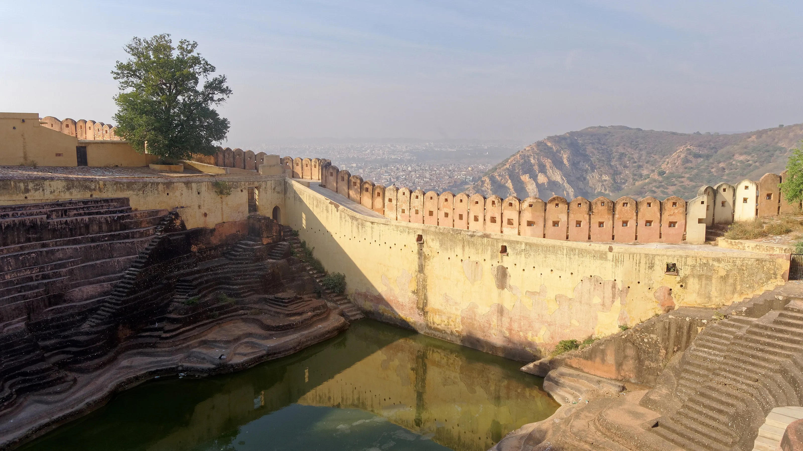 Nahargarh Fort's zigzag wall descending to a stepped reservoir on the ridge above Jaipur