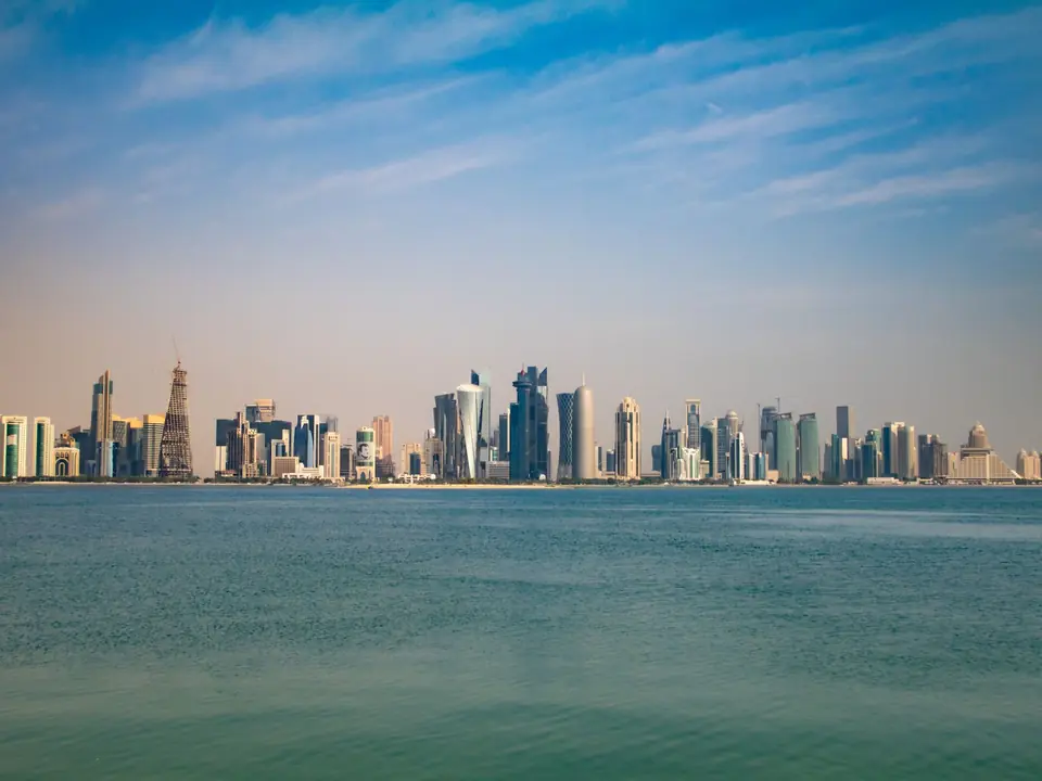 Captivating view of Doha skyline from the Corniche, featuring modern architecture under a clear blue sky