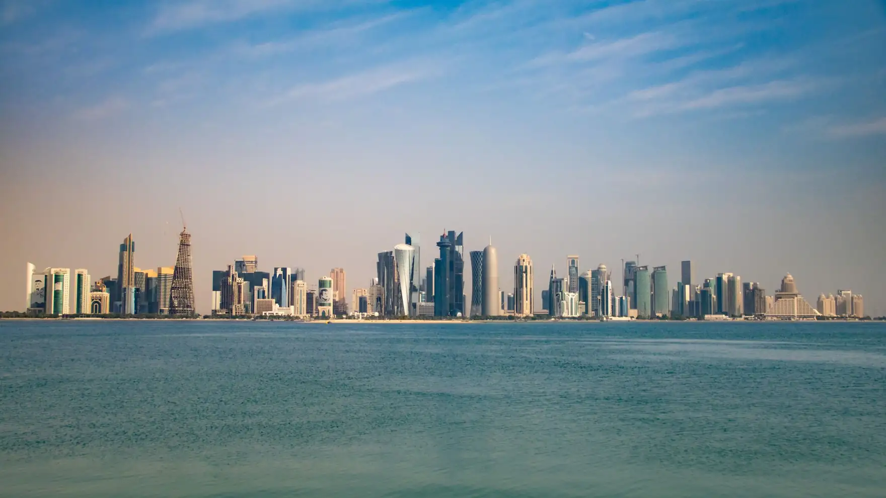 Captivating view of Doha skyline from the Corniche, featuring modern architecture under a clear blue sky