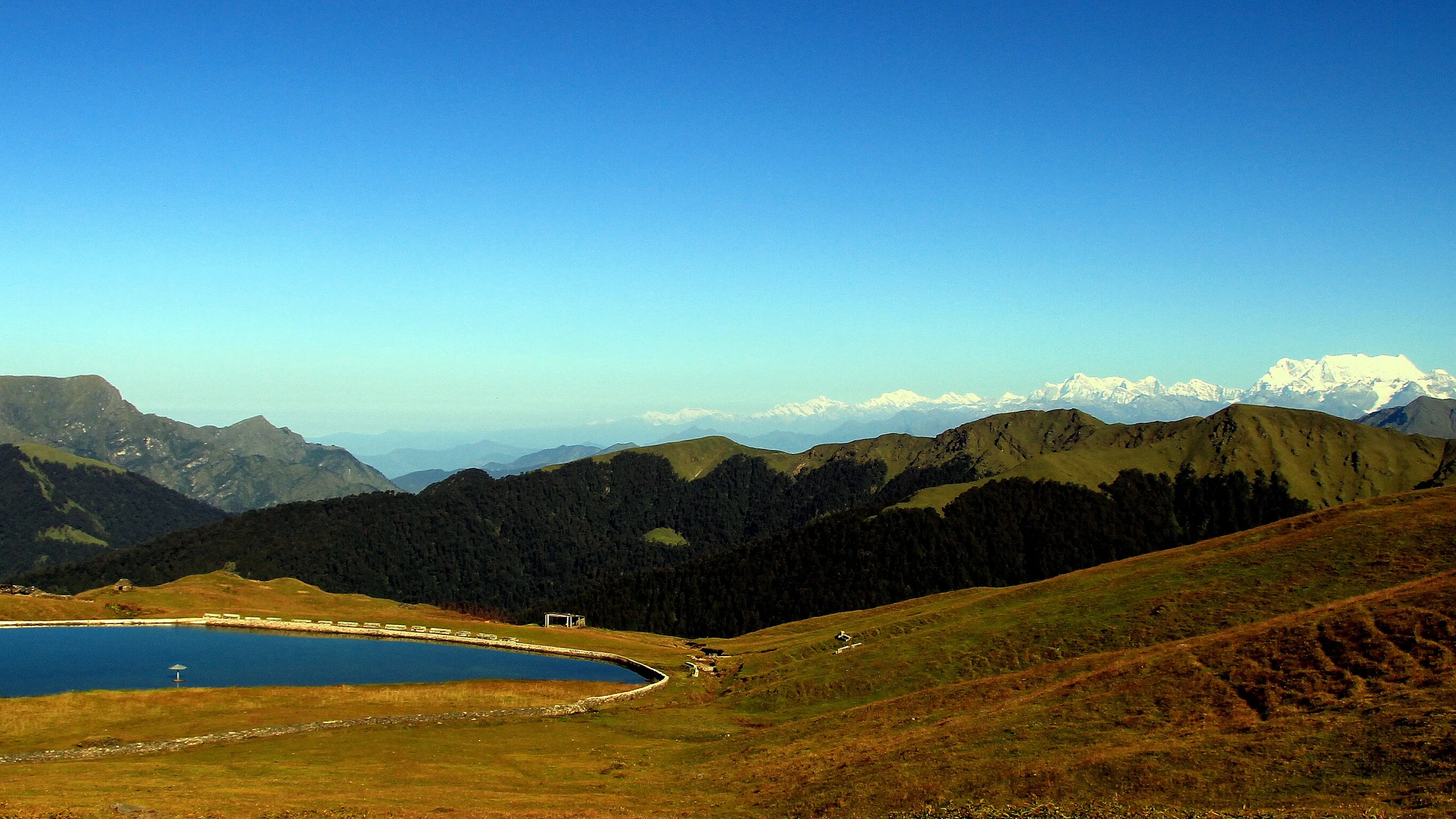 Bedni Bugyal meadows and the lake on the way to Roopkund, with the peaks behind