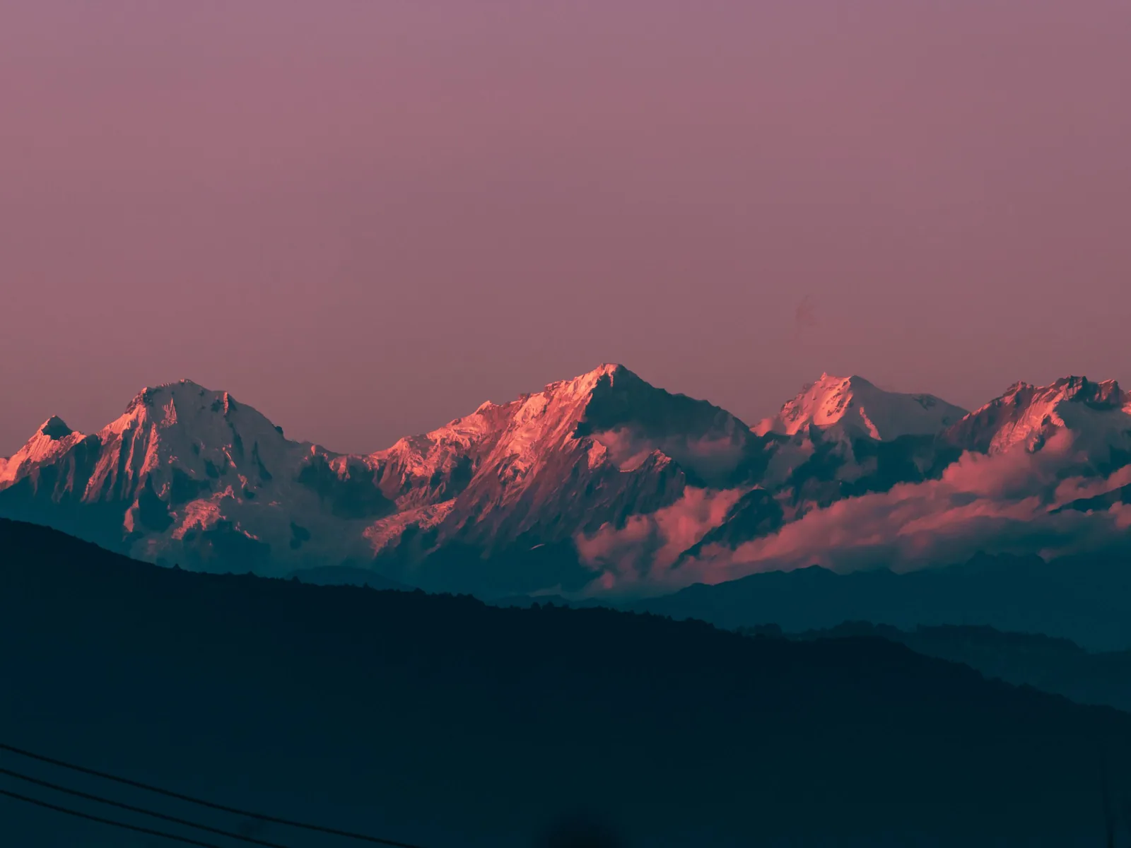 Breathtaking view of Kanchenjunga bathed in sunset hues, showcasing stunning Himalayan landscape