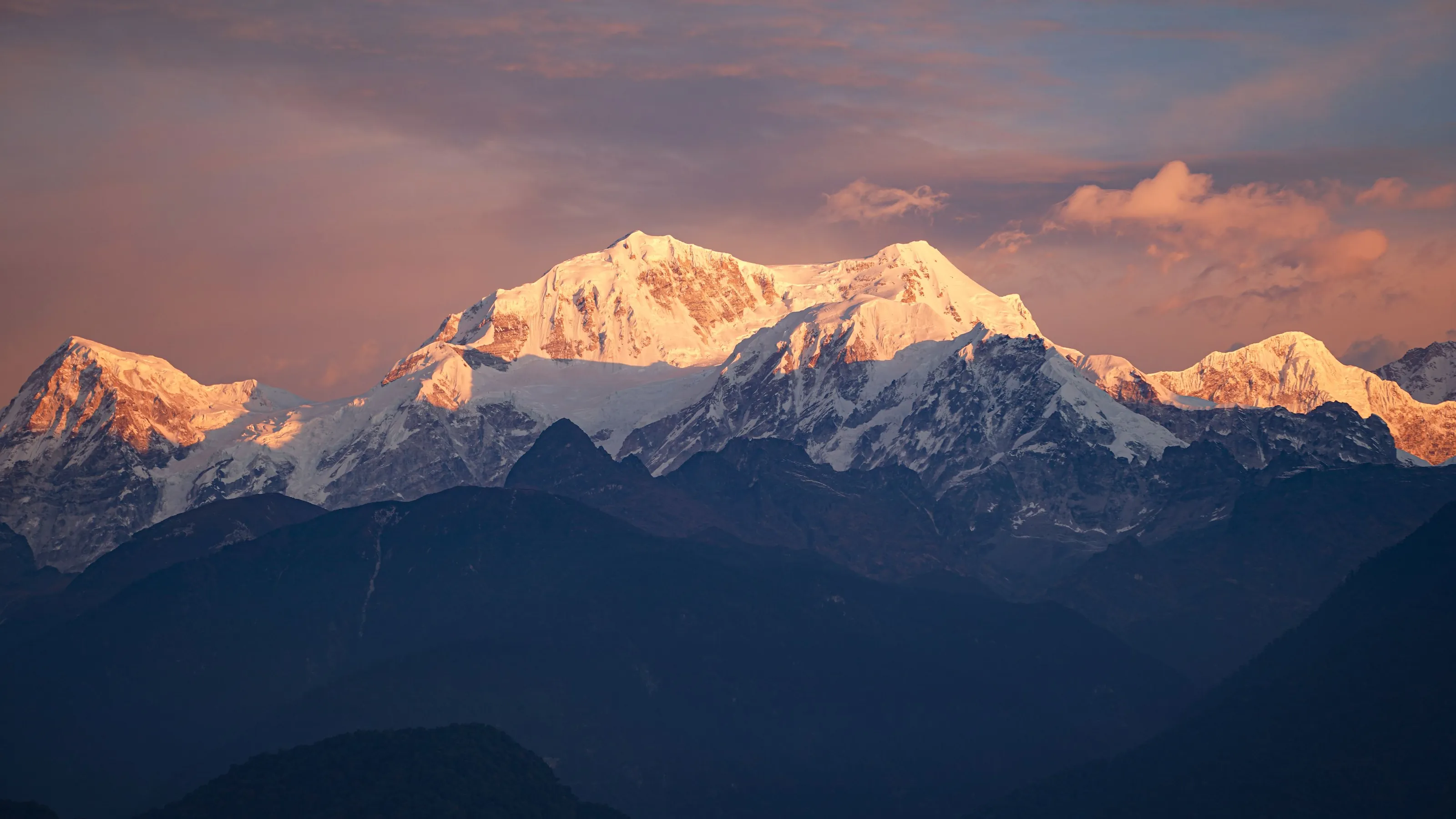 Kanchenjunga lit pink at dawn above the Sikkim ridges
