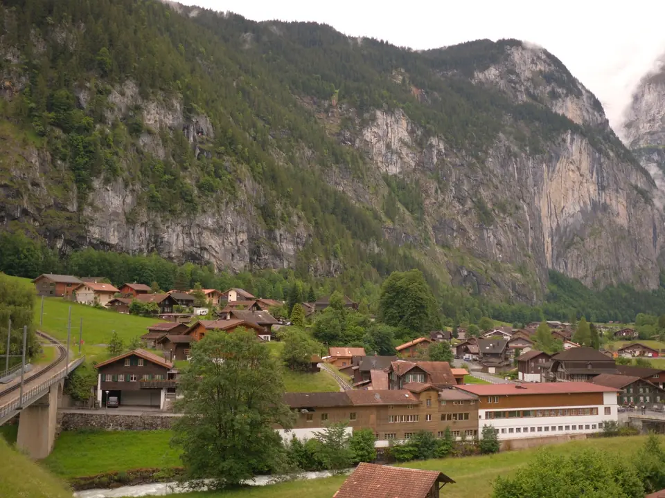 Lauterbrunnen village nestled amidst the Swiss Alps, showcasing charming chalets and stunning mountain views