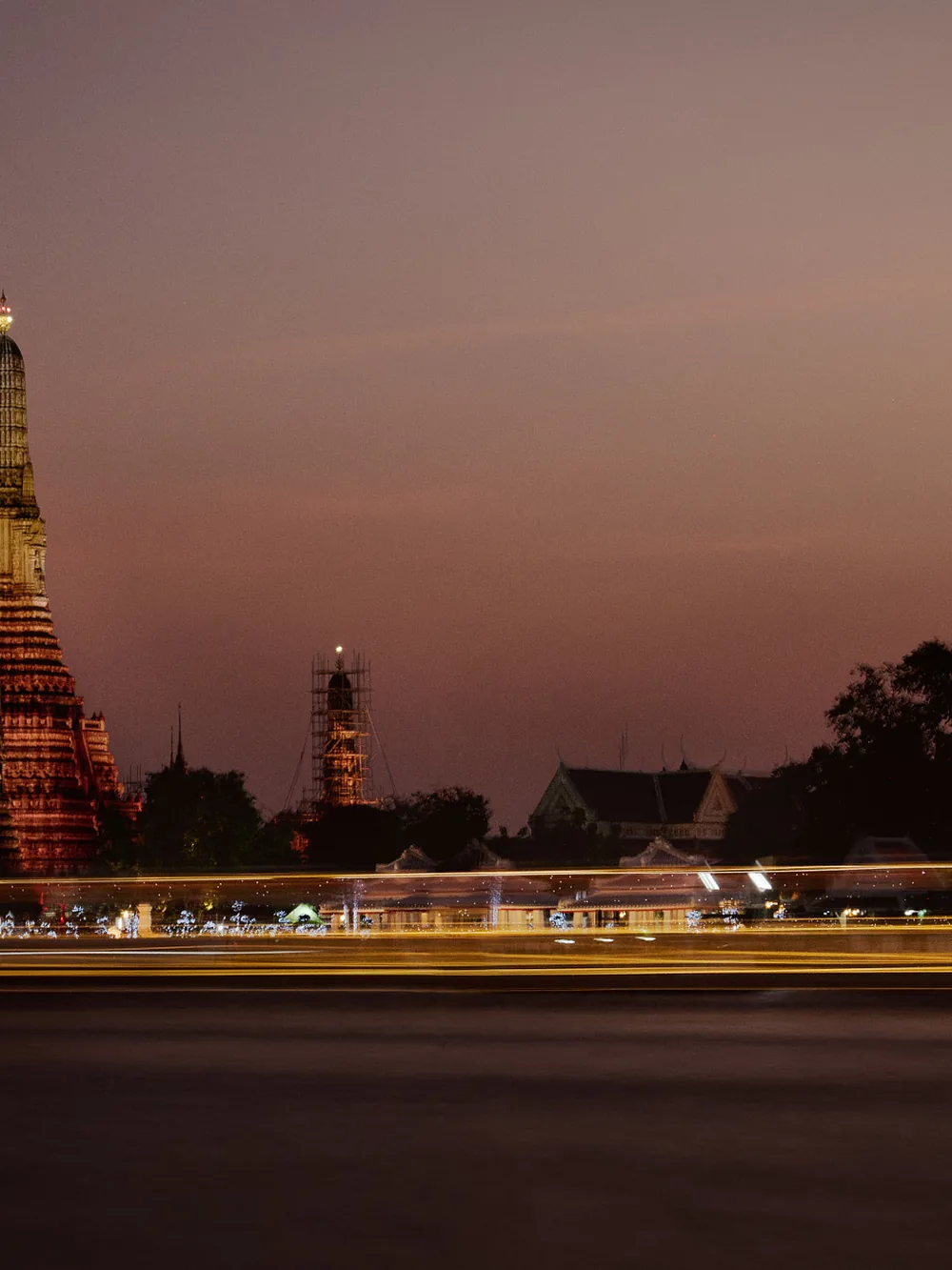 Wat Arun lit at night on the Chao Phraya river