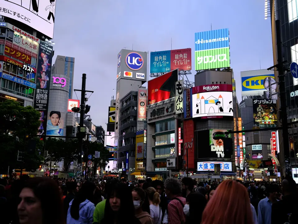 Bustling street scene at Shibuya Crossing, a famous urban landmark in Tokyo, Japan, at night