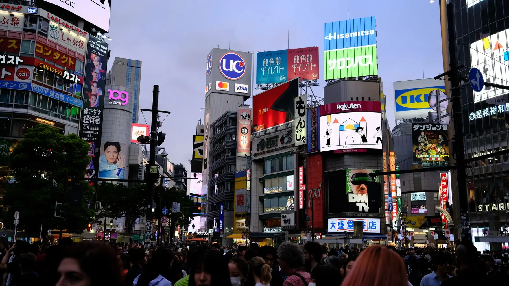 Bustling street scene at Shibuya Crossing, a famous urban landmark in Tokyo, Japan, at night