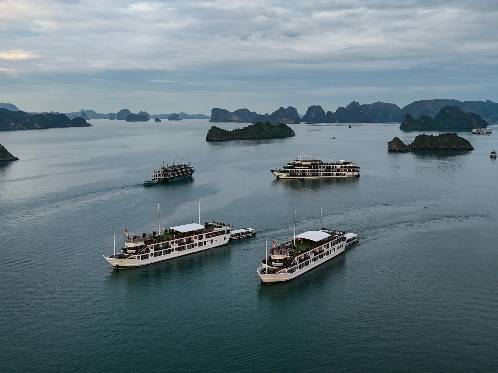 A group of boats floating on top of a large body of water