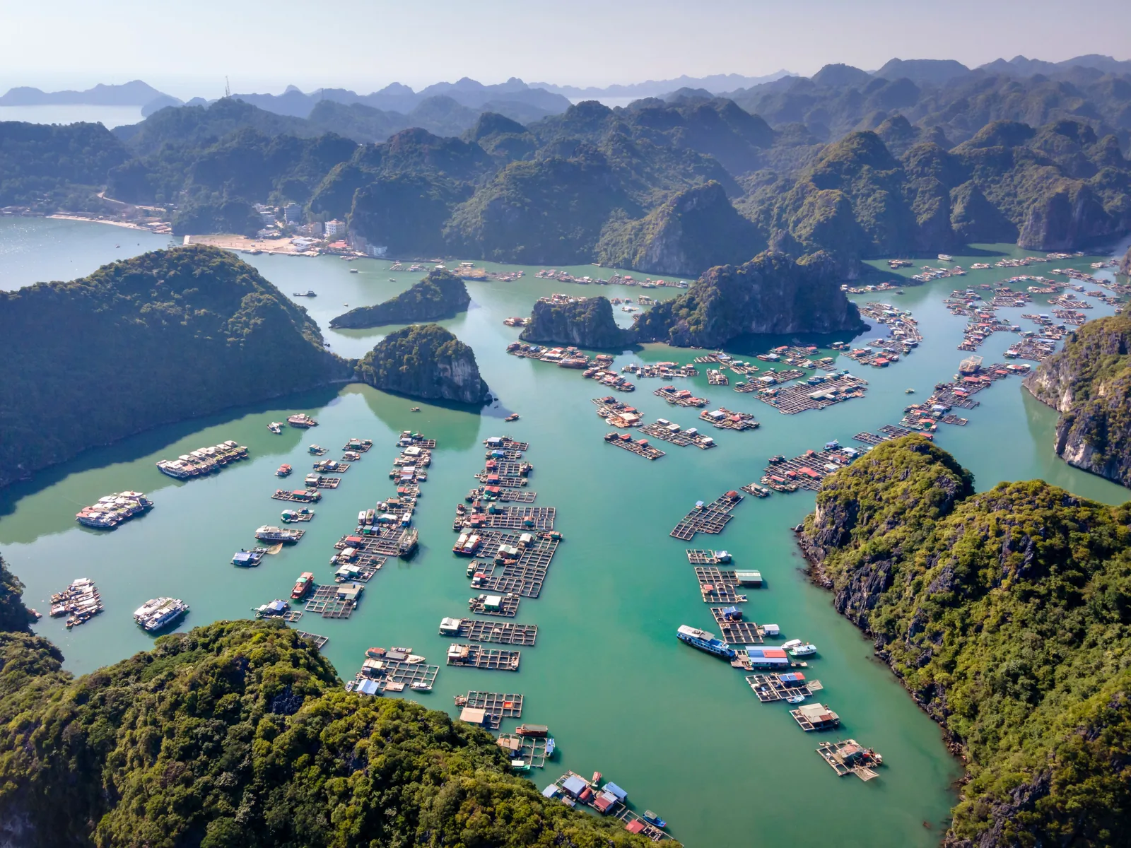 Stunning aerial shot of Ha Long Bay's turquoise waters and floating villages